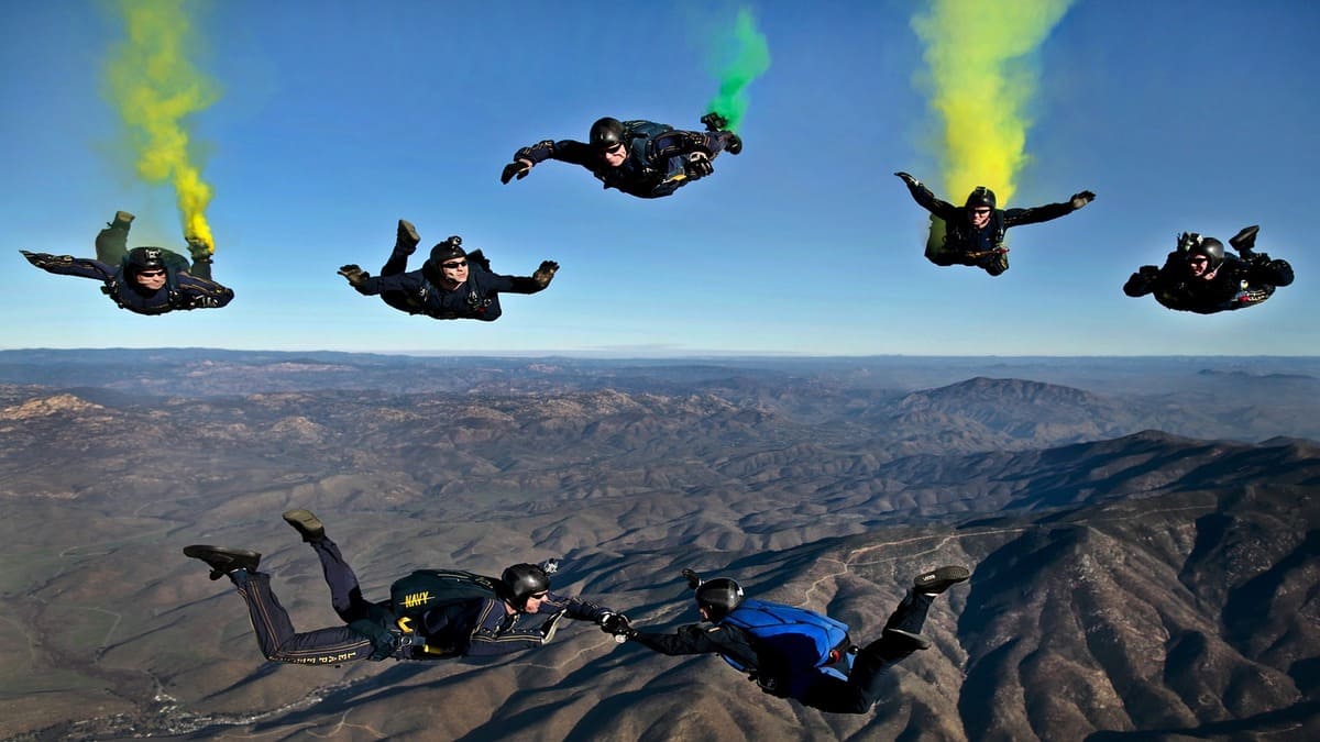 a group of people skydiving in india